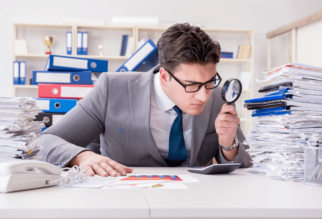 A man checking the documents proving that a business has been trading legally.