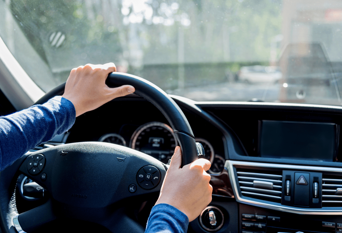 A man driving a vehicle equipped with an extension on his motor trade policy insurance.