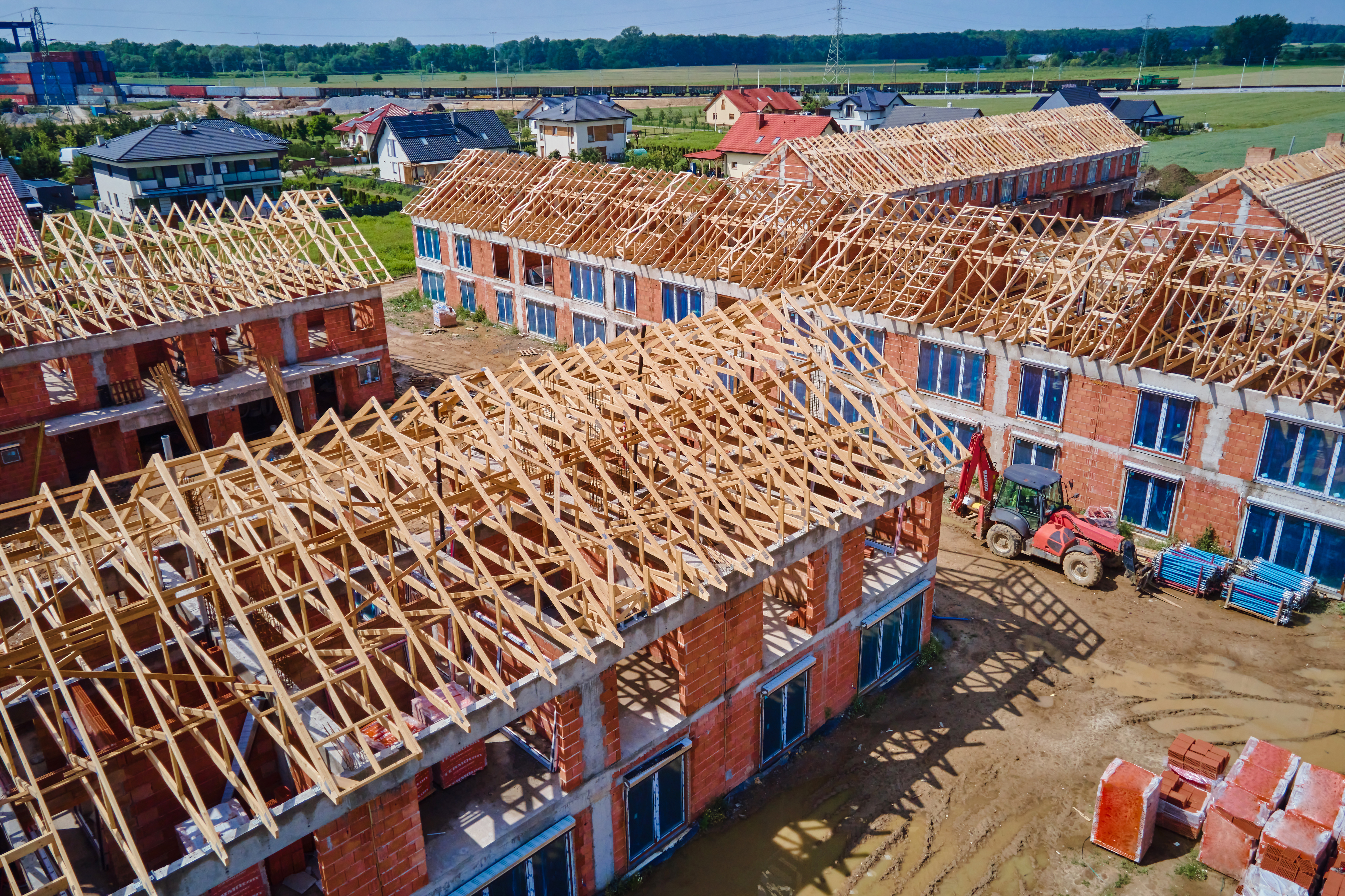 Timber frame house under construction showing construction of timber frame houses and structural framework for residential property.
