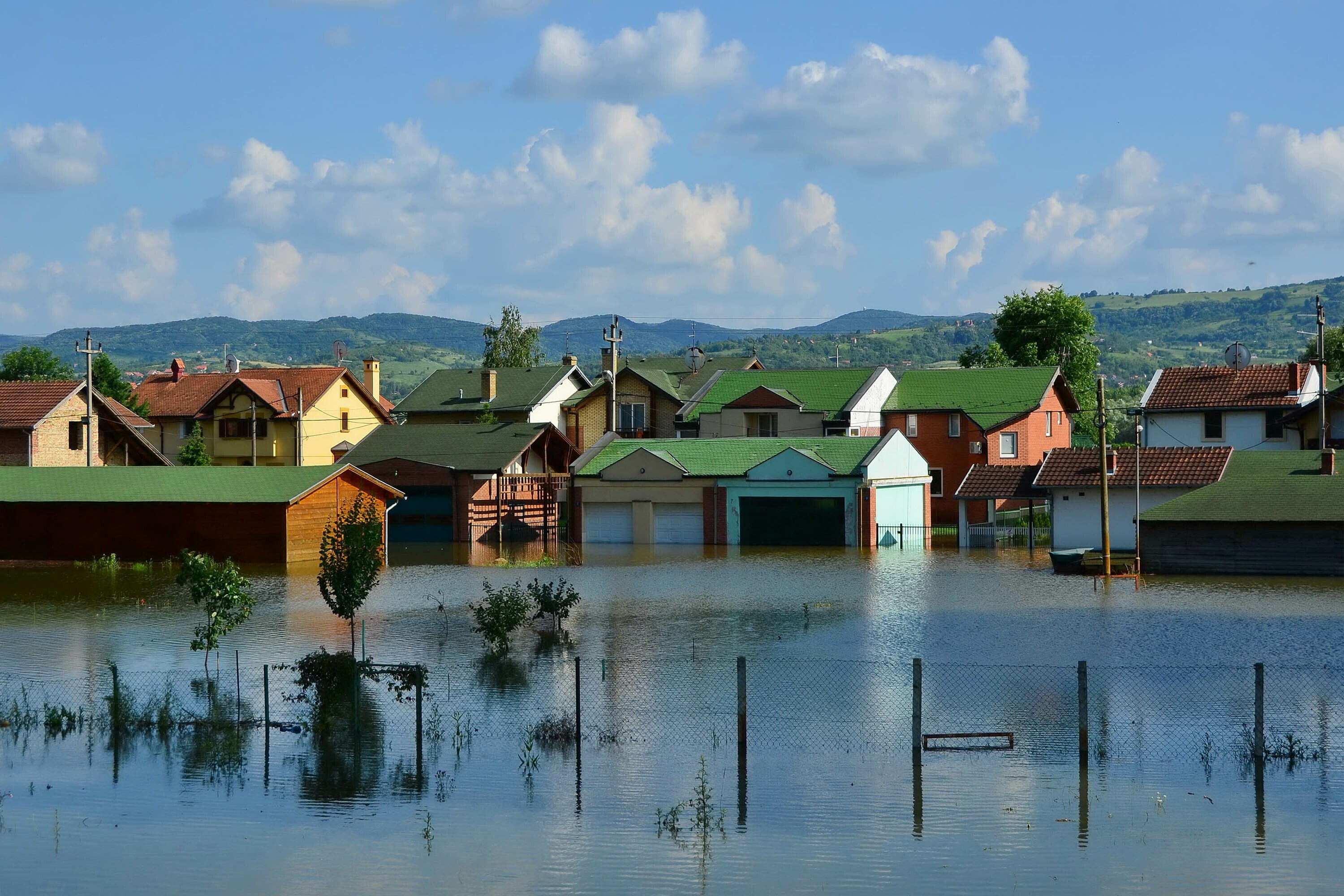 Flooded residential street showing impact of flooding and importance of flood zone insurance for homeowners.